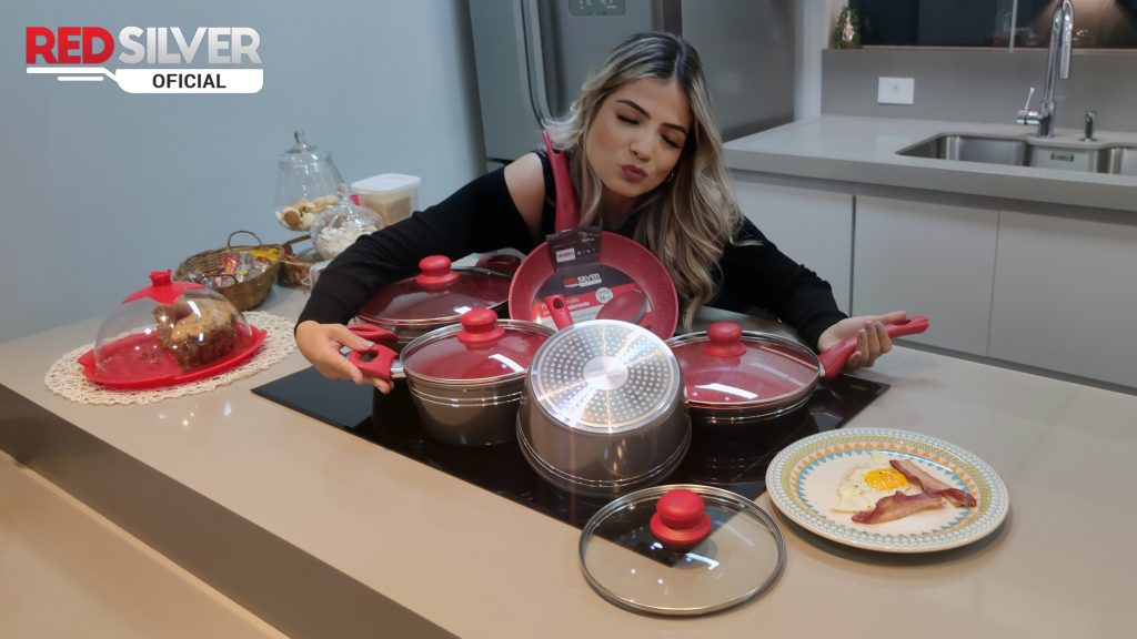Cliente satisfeito preparando refeição saudável com conjunto de panelas RedSilver na cozinha moderna